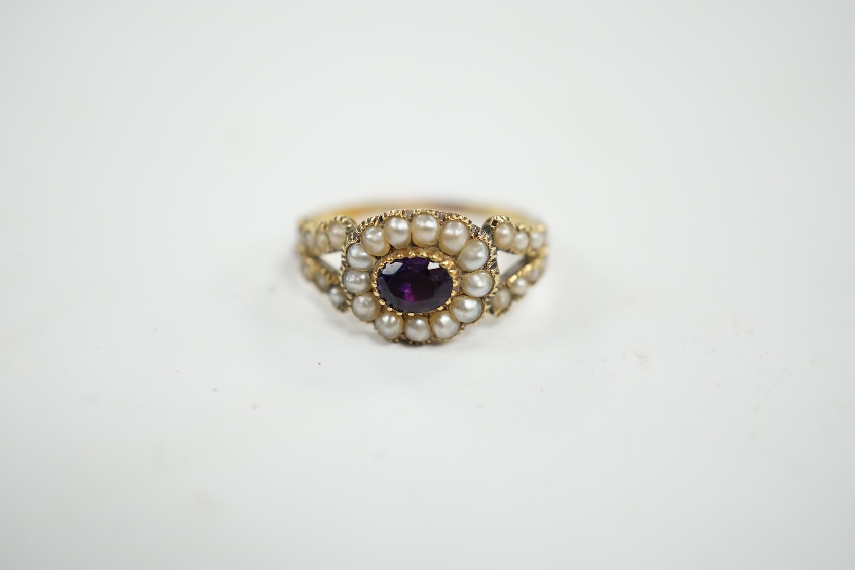 A Victorian yellow metal amethyst and seed pearl cluster set ring, size P/Q, gross weight 3 grams. Condition - poor